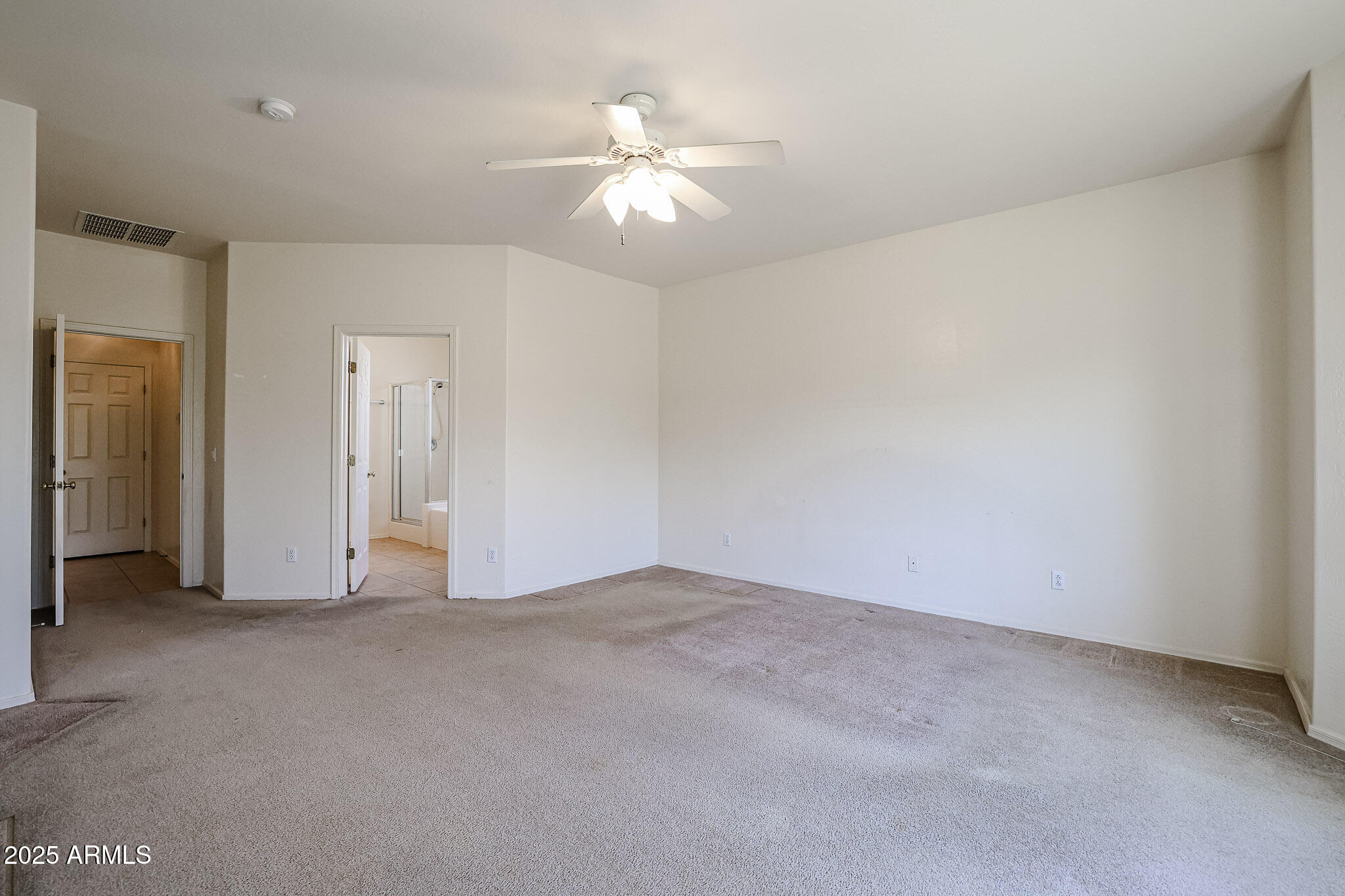 16617 North 40th Drive Phoenix, AZ 85053 - Photo 5 of 15 an empty room with chandelier fan and closet