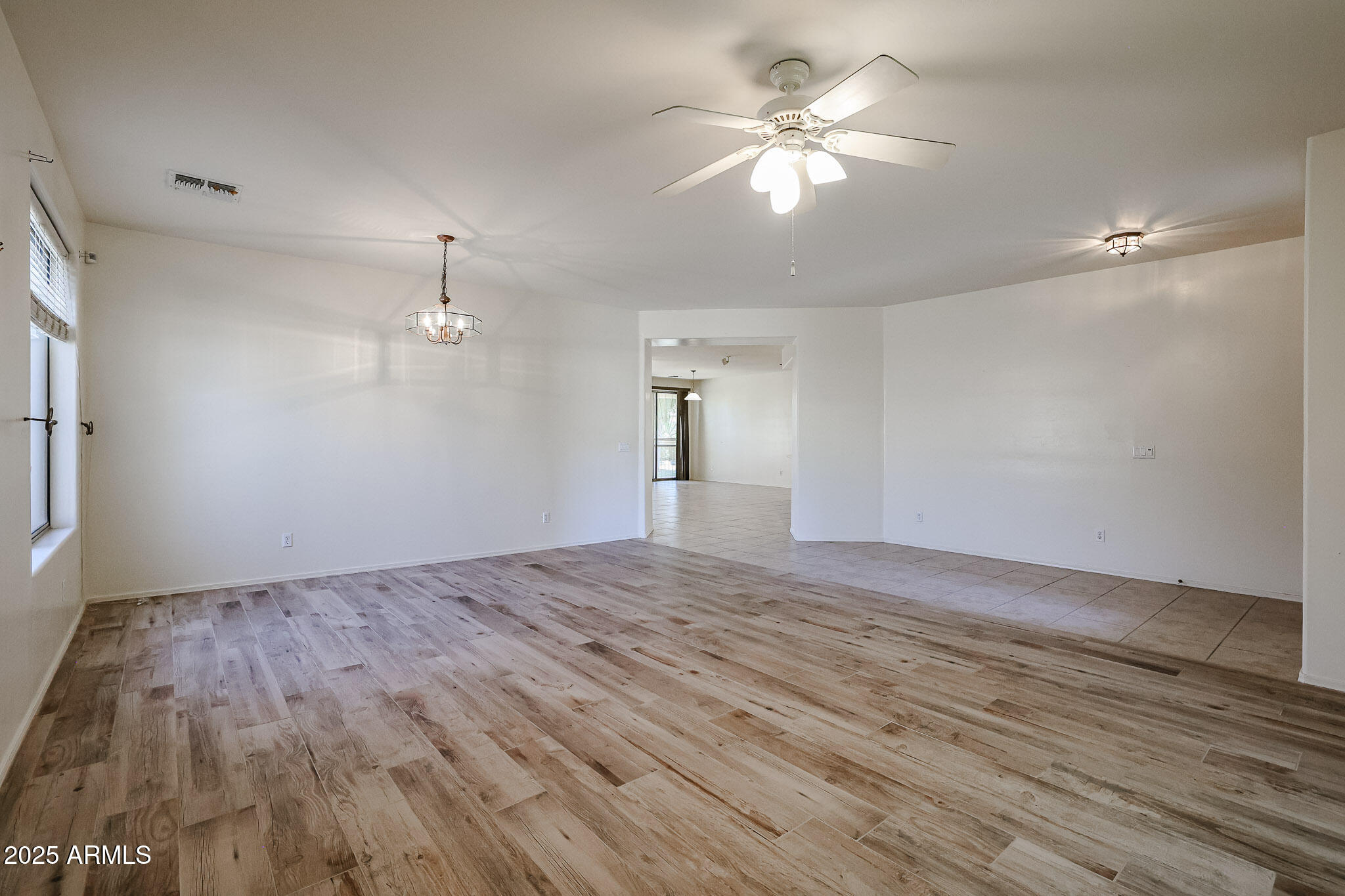 16617 North 40th Drive Phoenix, AZ 85053 - Photo 9 of 15 a view of empty room with wooden floor and fan