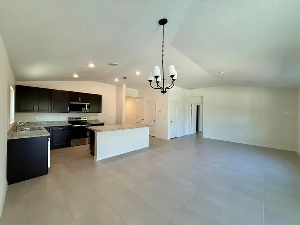 a view of kitchen with refrigerator stove and microwave