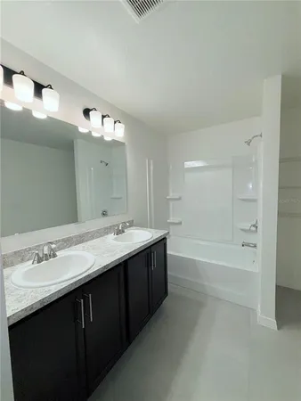 a bathroom with a sink a mirror and a bathtub