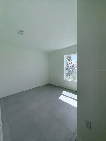 a view of an empty room and a window