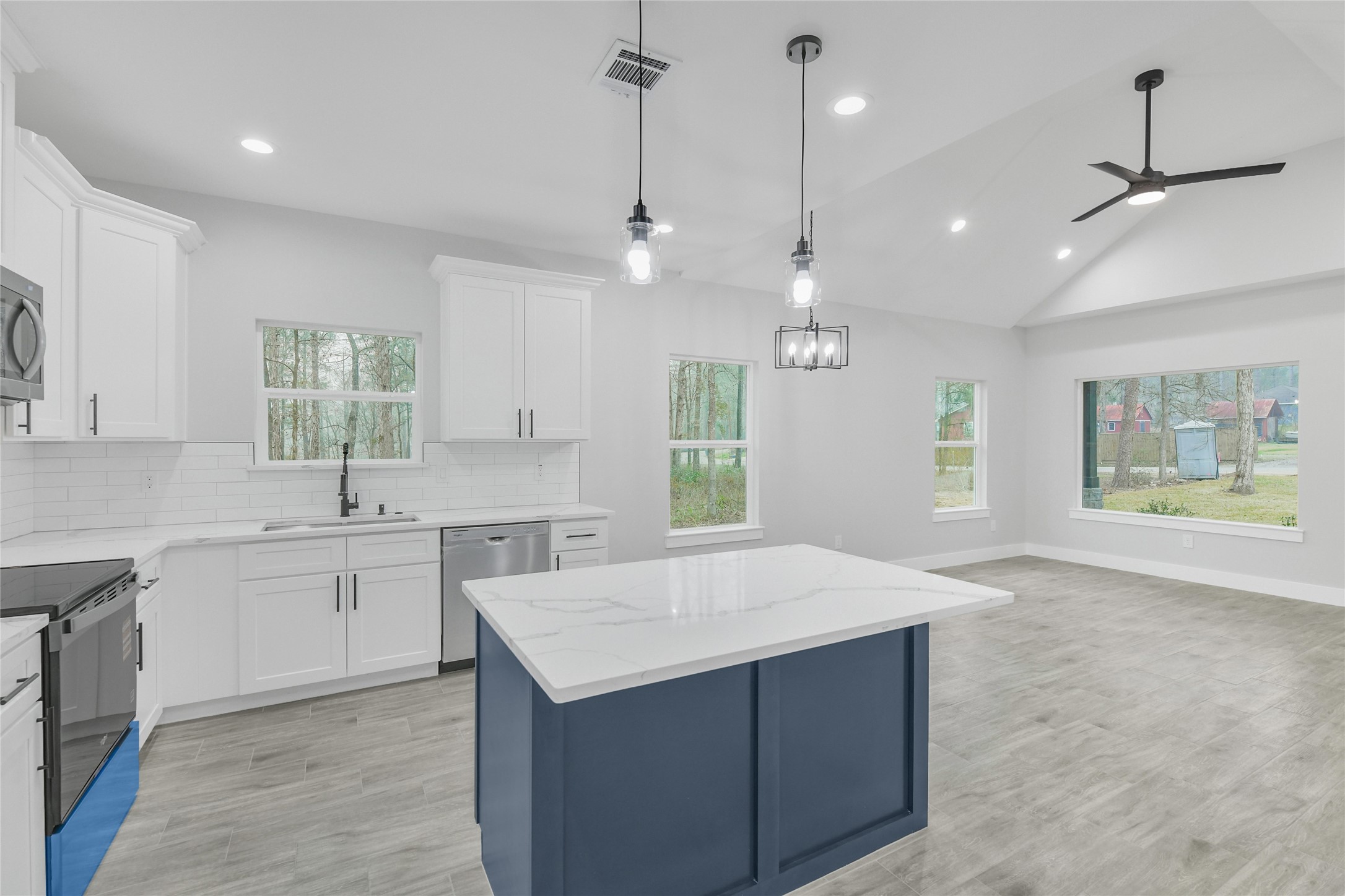 15117 Austin Road Willis, TX 77378 - Photo 11 of 35 a kitchen with kitchen island a sink stainless steel appliances and cabinets