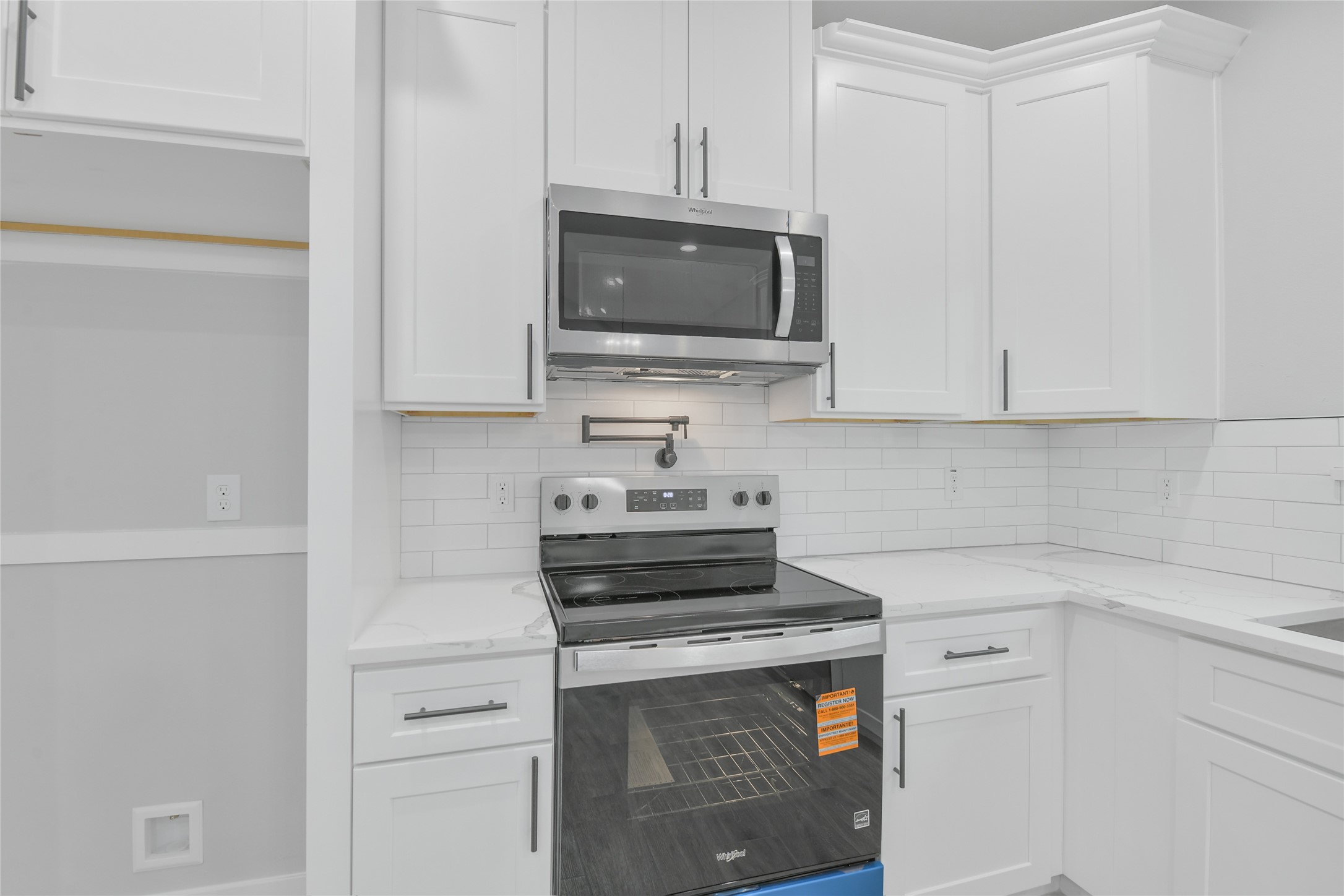 15117 Austin Road Willis, TX 77378 - Photo 13 of 35 a kitchen with white cabinets stainless steel appliances and sink