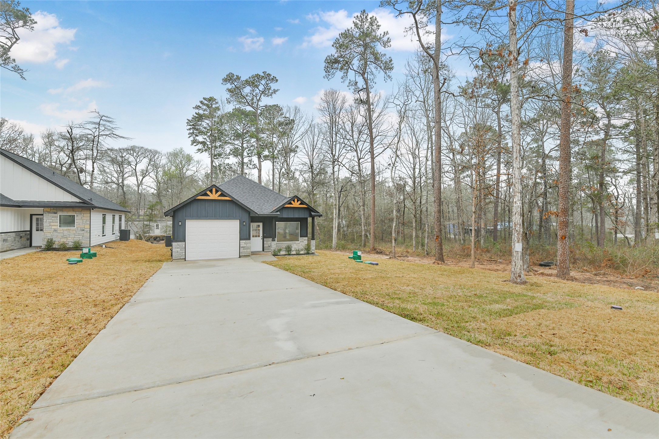 15117 Austin Road Willis, TX 77378 - Photo 2 of 35 a house with trees in front of it