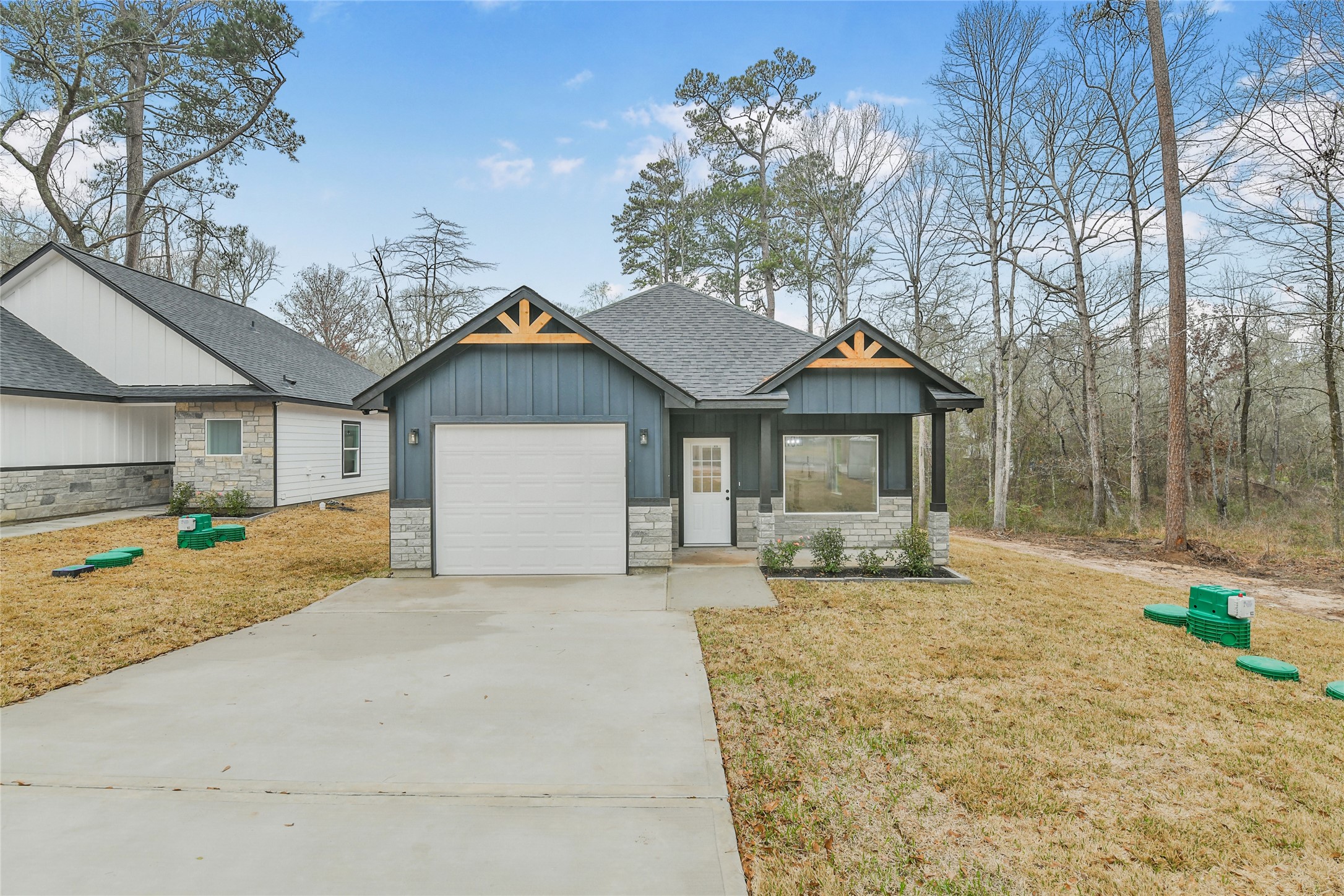 15117 Austin Road Willis, TX 77378 - Photo 32 of 35 a front view of a house with a yard outdoor seating and garage