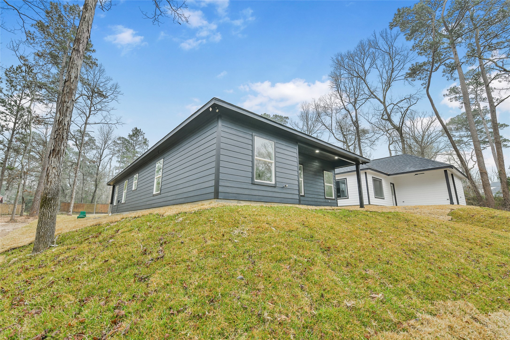 15117 Austin Road Willis, TX 77378 - Photo 35 of 35 a house with trees in the background
