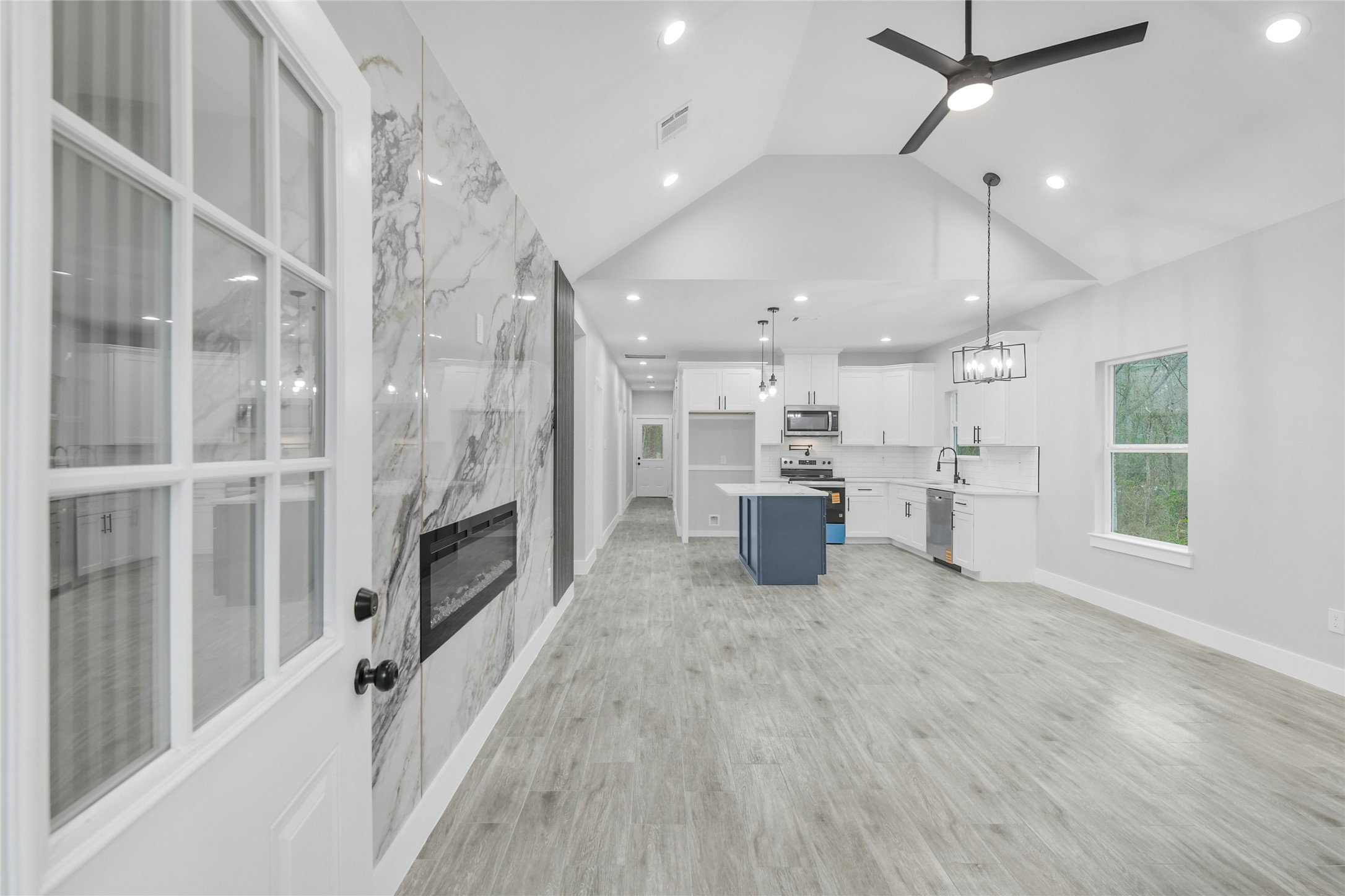 15117 Austin Road Willis, TX 77378 - Photo 4 of 35 a view of a kitchen with furniture and a ceiling fan