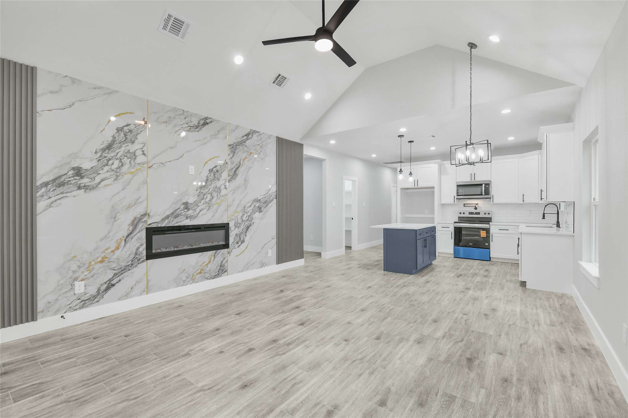 15117 Austin Road Willis, TX 77378 - Photo 7 of 35 a large kitchen with kitchen island a stove a sink stainless steel appliances and cabinets