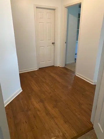 an empty room with wooden floor