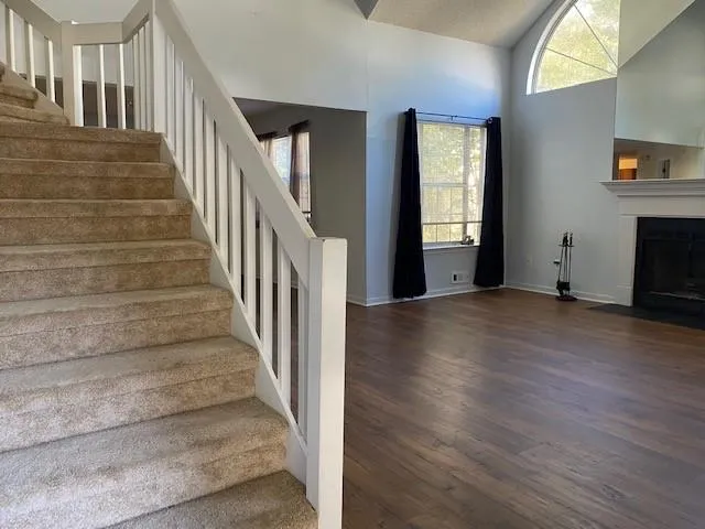 a view of an entryway with wooden floor and stairs