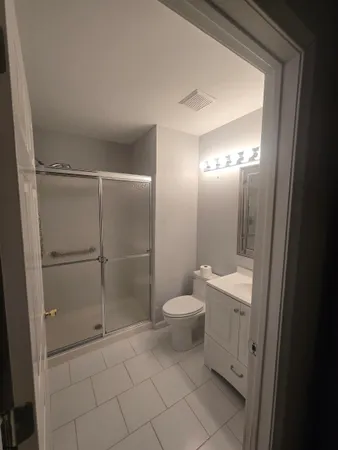 a bathroom with a toilet and a shower