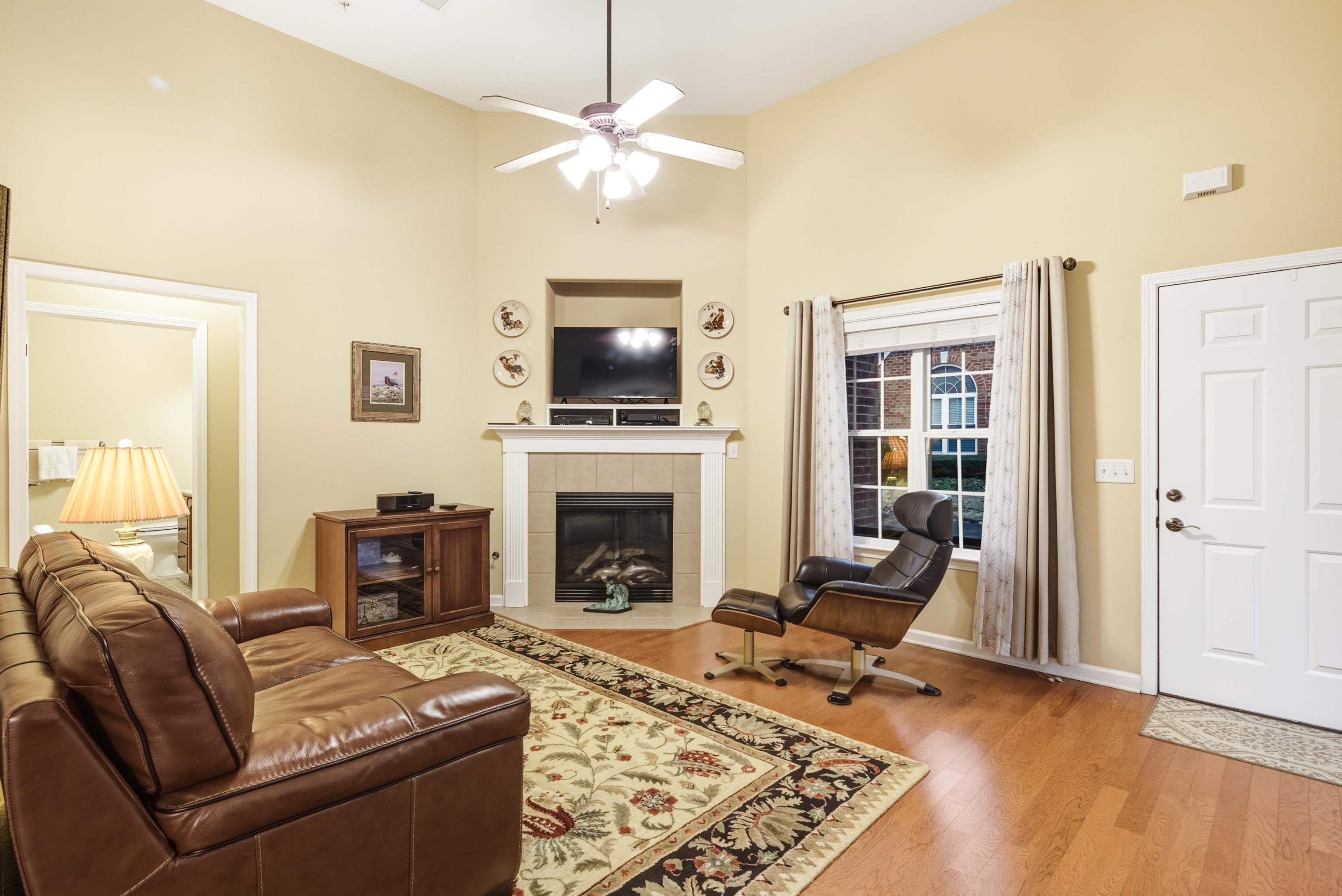 43 Peyton Ridge Drive, Unit 40 Collierville, TN 38017 - Photo 4 of 31 a living room with furniture a fireplace and a flat screen tv