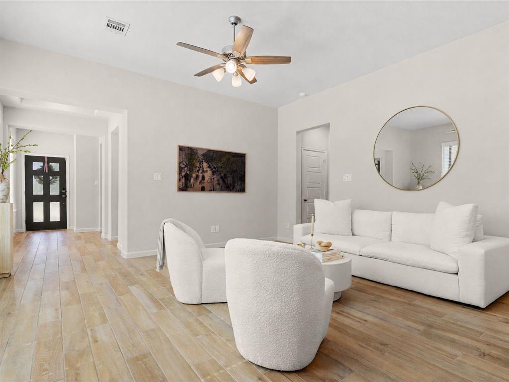 166 Palo Duro Bend Rhome, TX 76078 - Photo 1 of 40 Spacious living room with abundant natural light and open-concept layout.