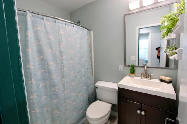 a view of hallway with window and wooden floor
