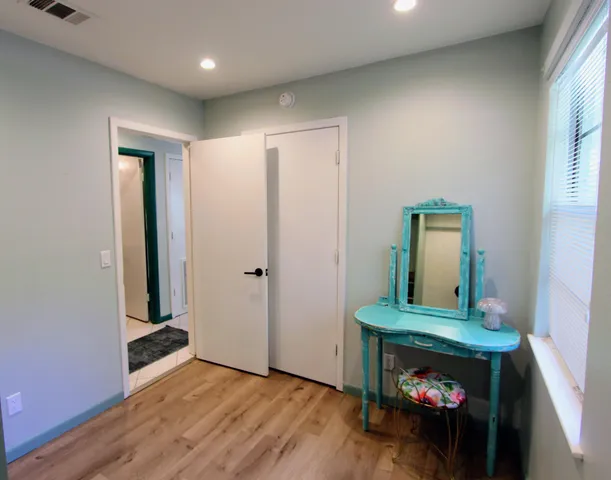 a bed sitting in a bedroom next to a window