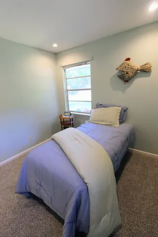 a bedroom that has a bed and a window in it