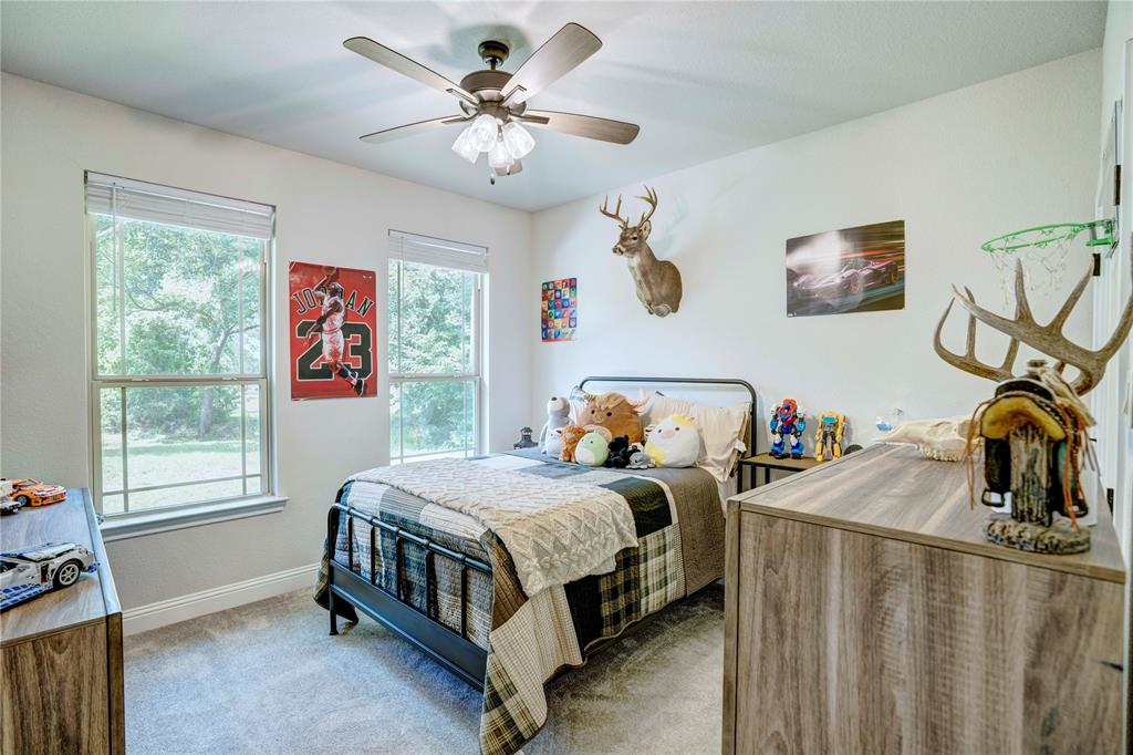 1355 Jay Bird Road Springtown, TX 76082 - Photo 34 of 40 a bedroom that has a bed and a window in it