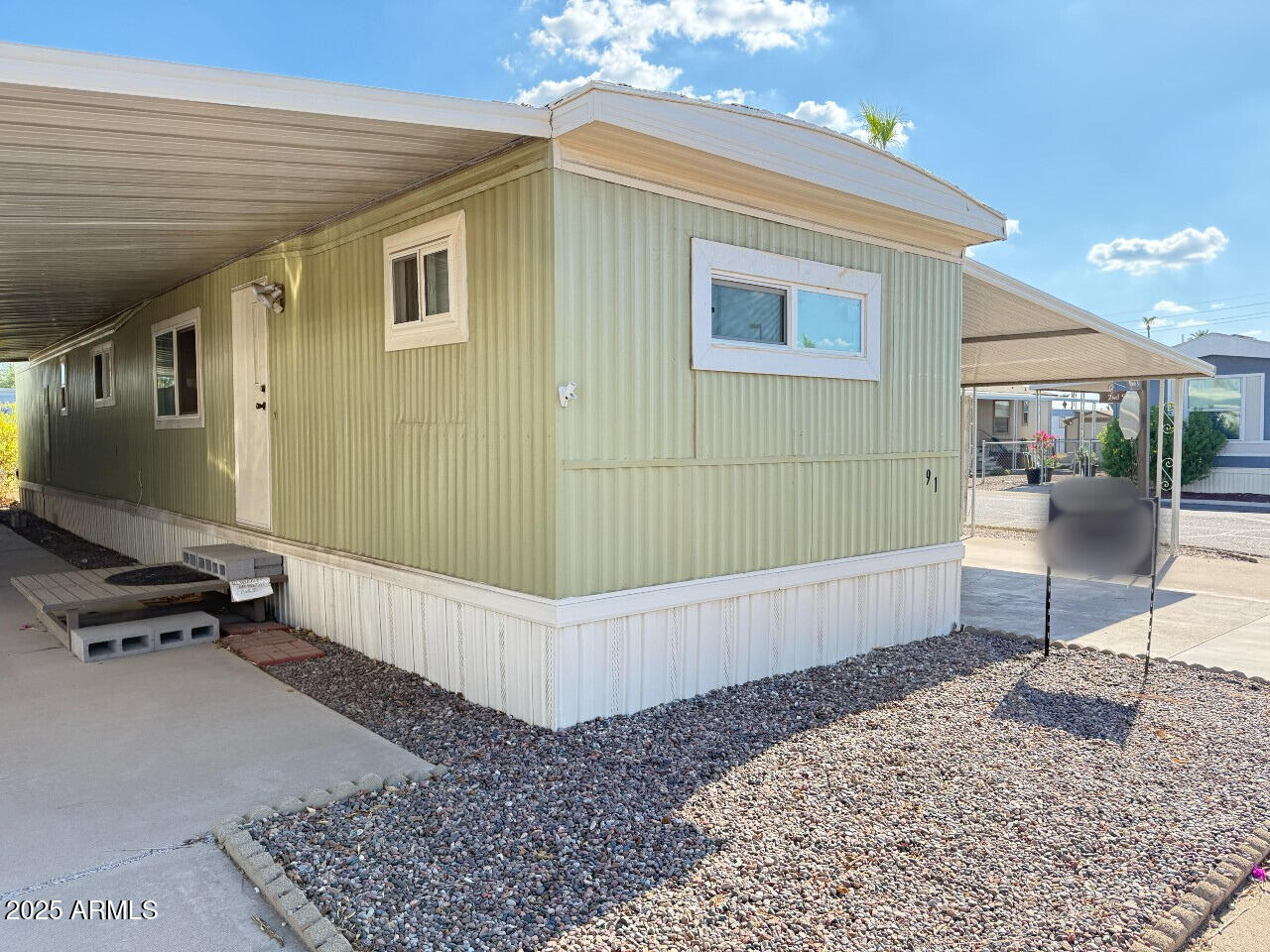 535 South Alma School Road, Unit 91 Mesa, AZ 85210 - Photo 2 of 26 a living room with a couch and a flat screen tv