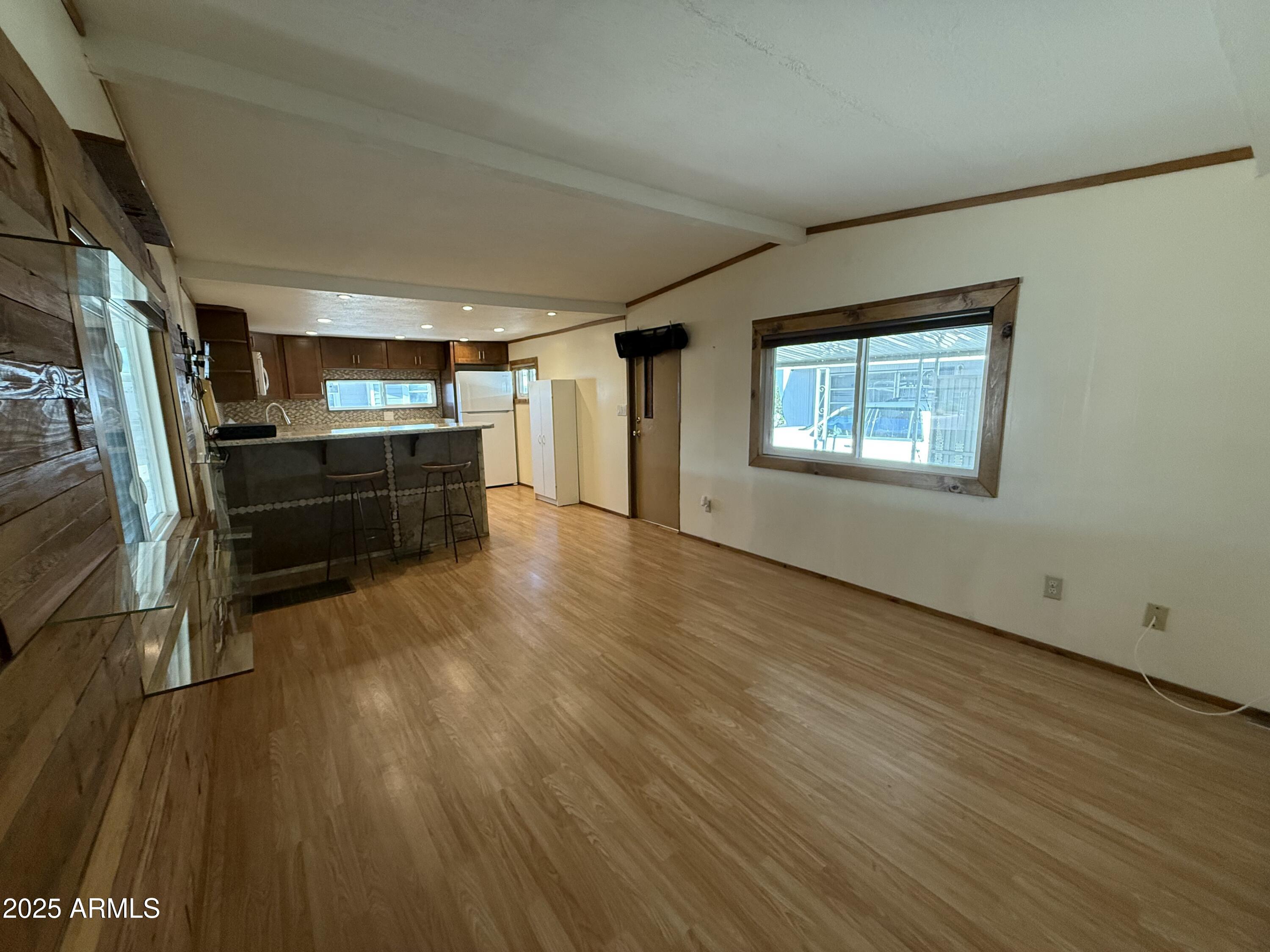 535 South Alma School Road, Unit 91 Mesa, AZ 85210 - Photo 5 of 26 a room with wooden floors and furniture