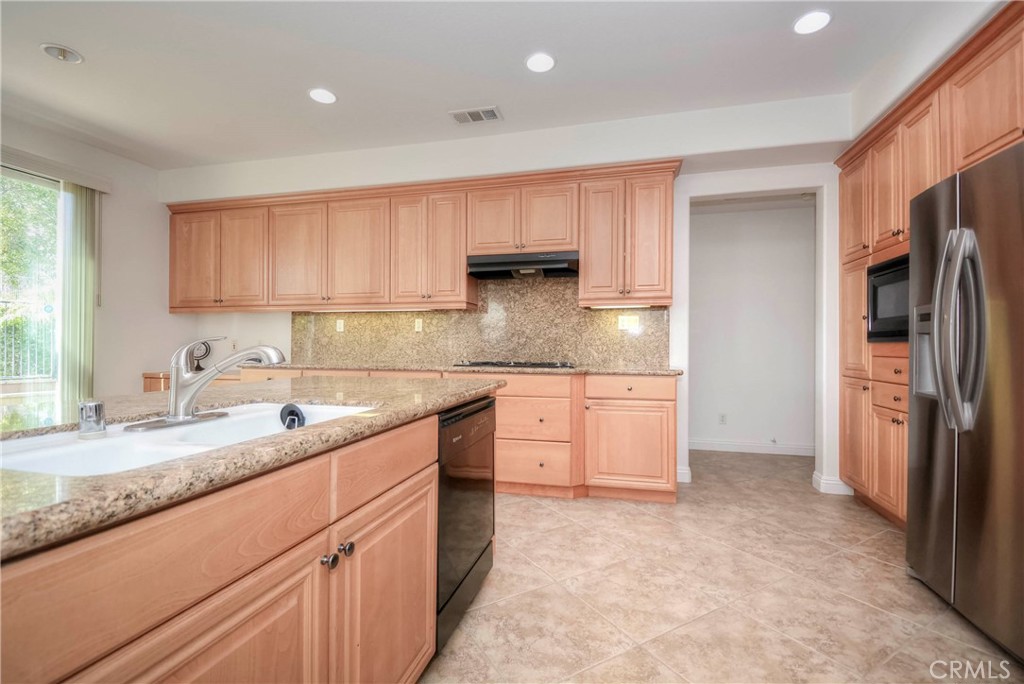 1803 Glen Rosa Street Upland, CA 91784 - Photo 11 of 68 a kitchen with granite countertop a sink stove and refrigerator
