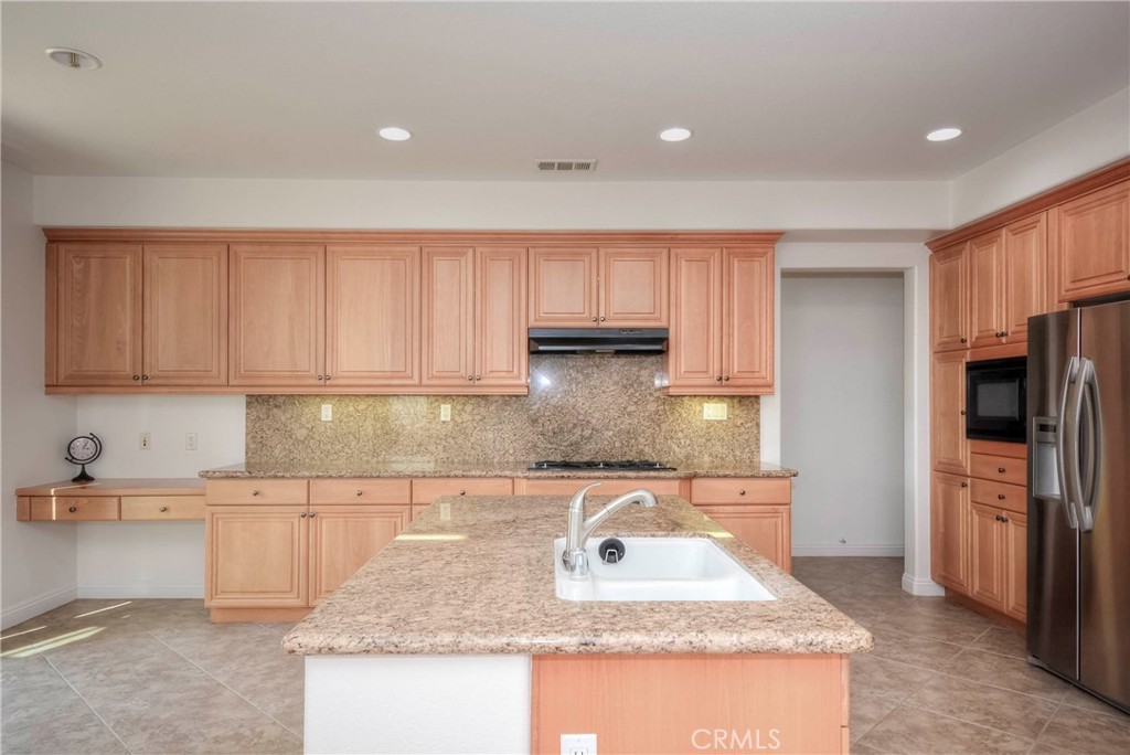 1803 Glen Rosa Street Upland, CA 91784 - Photo 5 of 68 a kitchen with stainless steel appliances granite countertop a sink stove and refrigerator