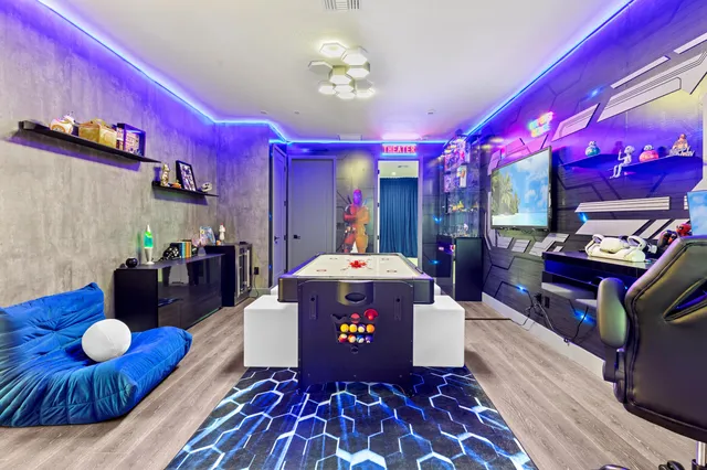 a bedroom with a large bed and a chandelier