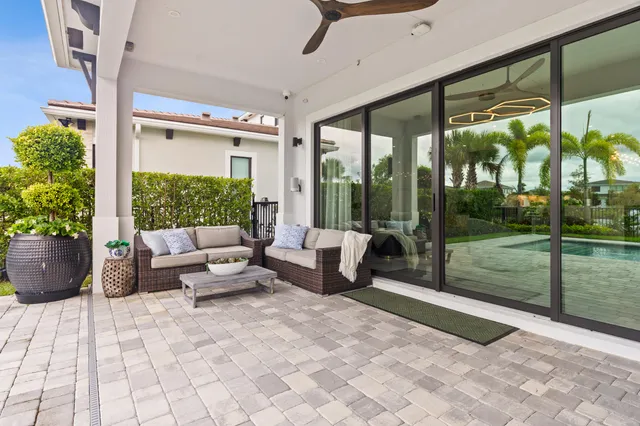 a view of a house with backyard porch and sitting area