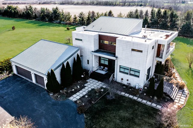 an aerial view of a house with a yard