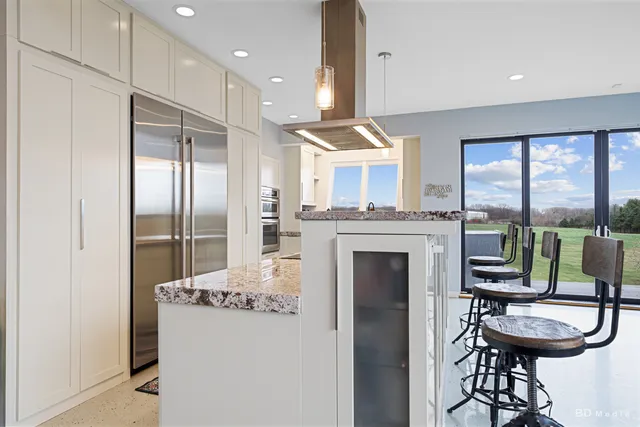 a view of a livingroom with furniture and a floor to ceiling window