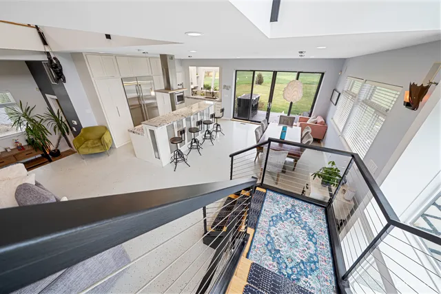 a view of a workspace with furniture and a window