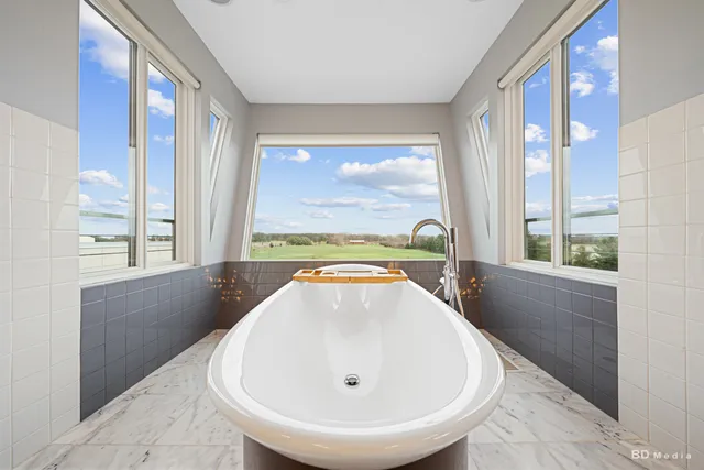 a bathroom with a sink a toilet a mirror and shower