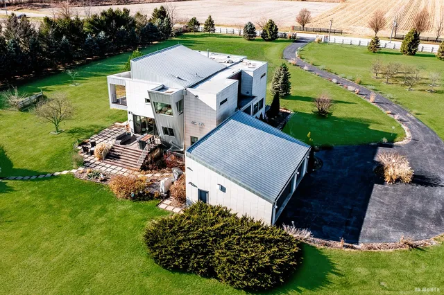 an aerial view of a house with garden space and street view