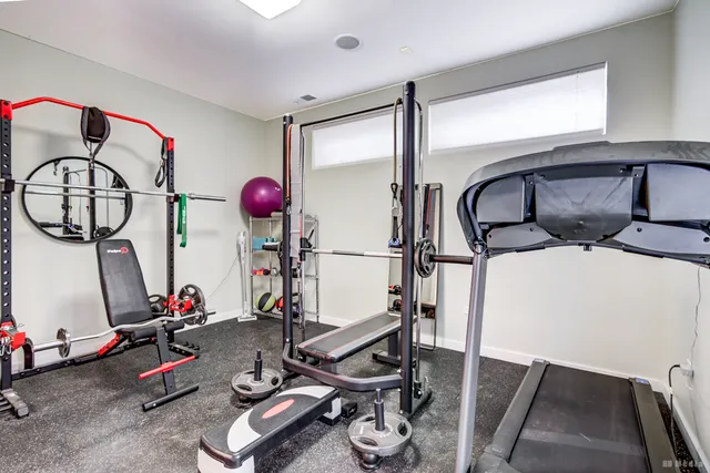 a view of a balcony with dining table & chairs