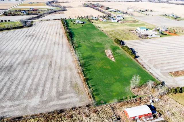 an aerial view of a house with garden space and ocean view