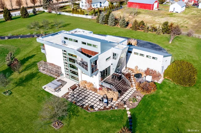 a living room with furniture and a floor to ceiling window