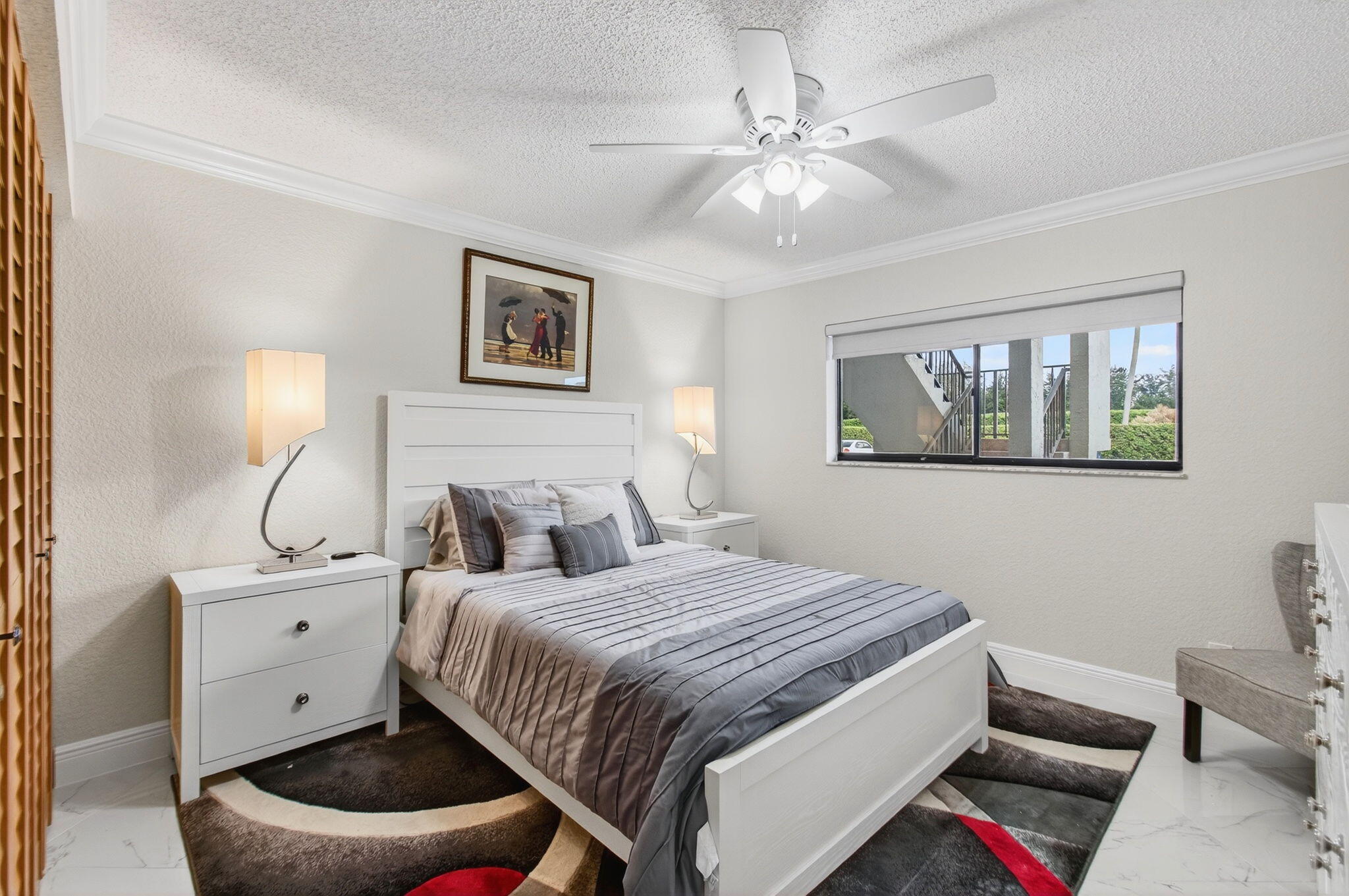 5574 Witney Drive, Unit 109 Delray Beach, FL 33484 - Photo 13 of 114 a bedroom with a bed and a chandelier