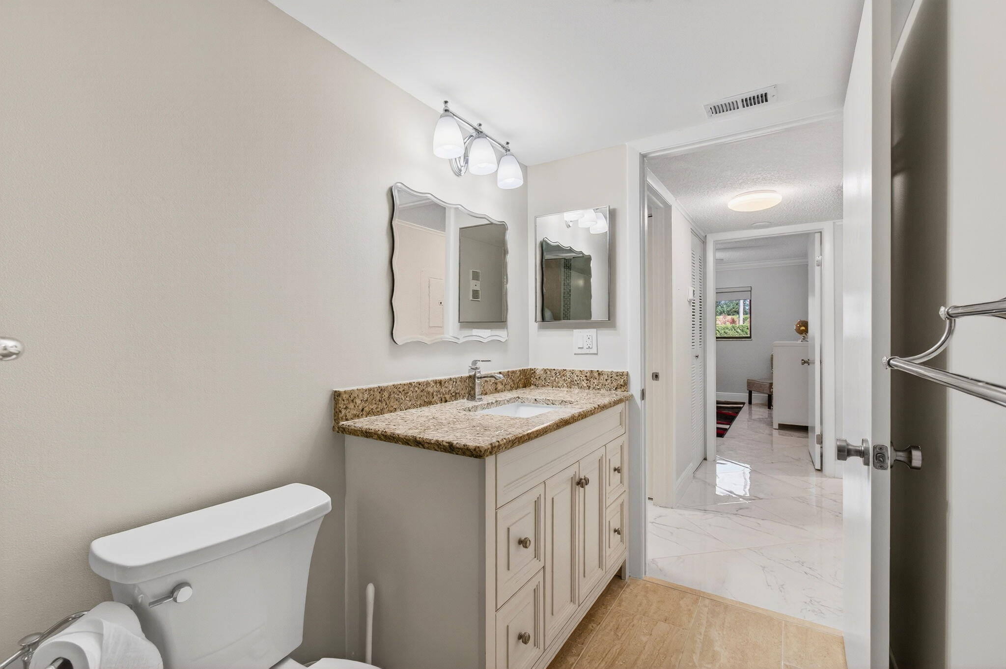 5574 Witney Drive, Unit 109 Delray Beach, FL 33484 - Photo 16 of 114 a spacious bathroom with a granite countertop sink a toilet mirror and a bathtub