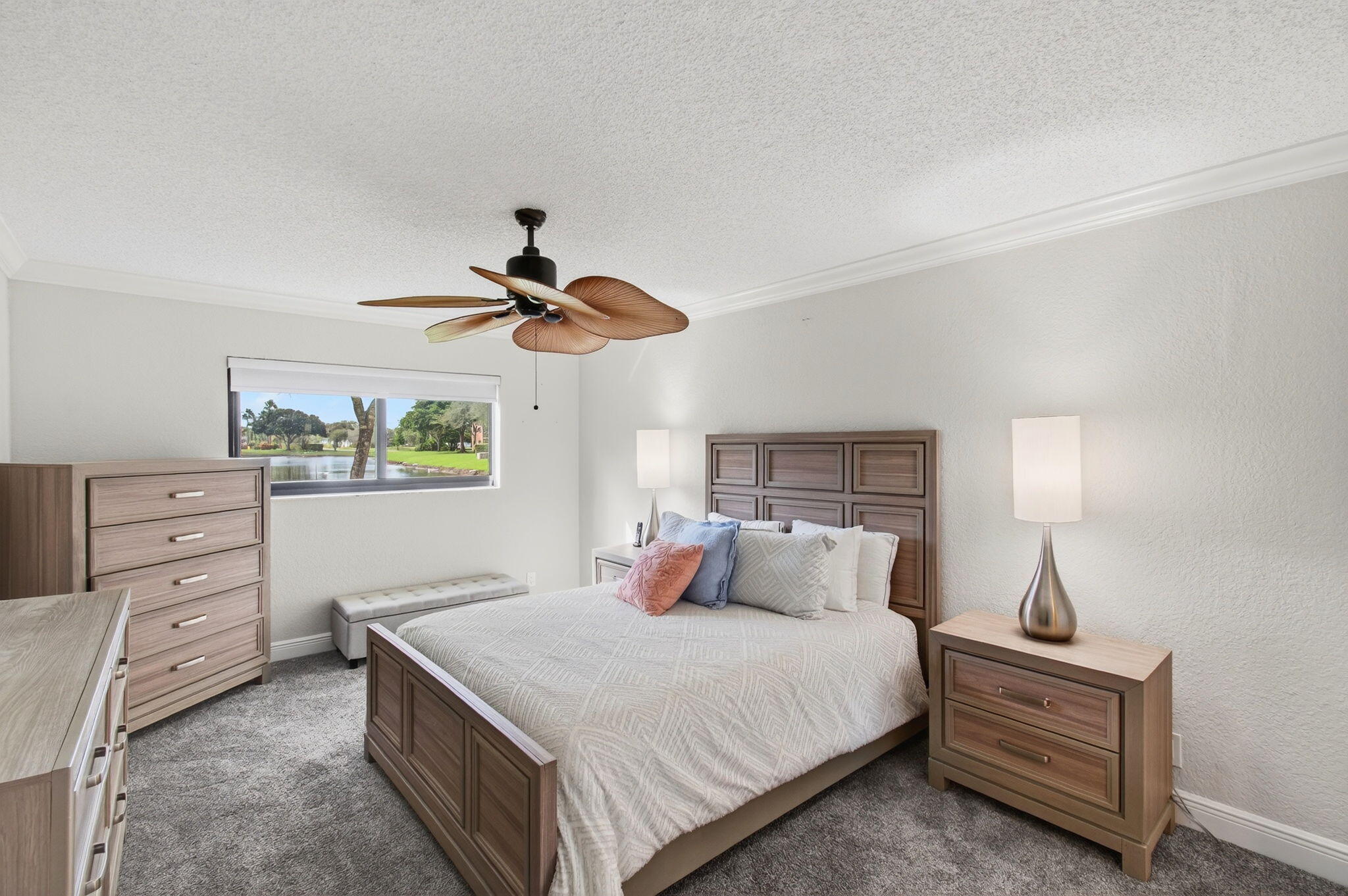 5574 Witney Drive, Unit 109 Delray Beach, FL 33484 - Photo 17 of 114 a bedroom with a bed and a chandelier
