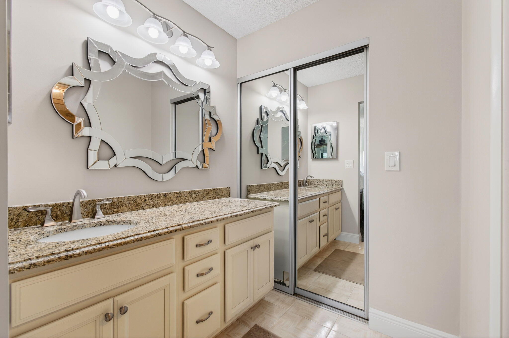 5574 Witney Drive, Unit 109 Delray Beach, FL 33484 - Photo 20 of 114 a spacious bathroom with a granite countertop sink mirror and double