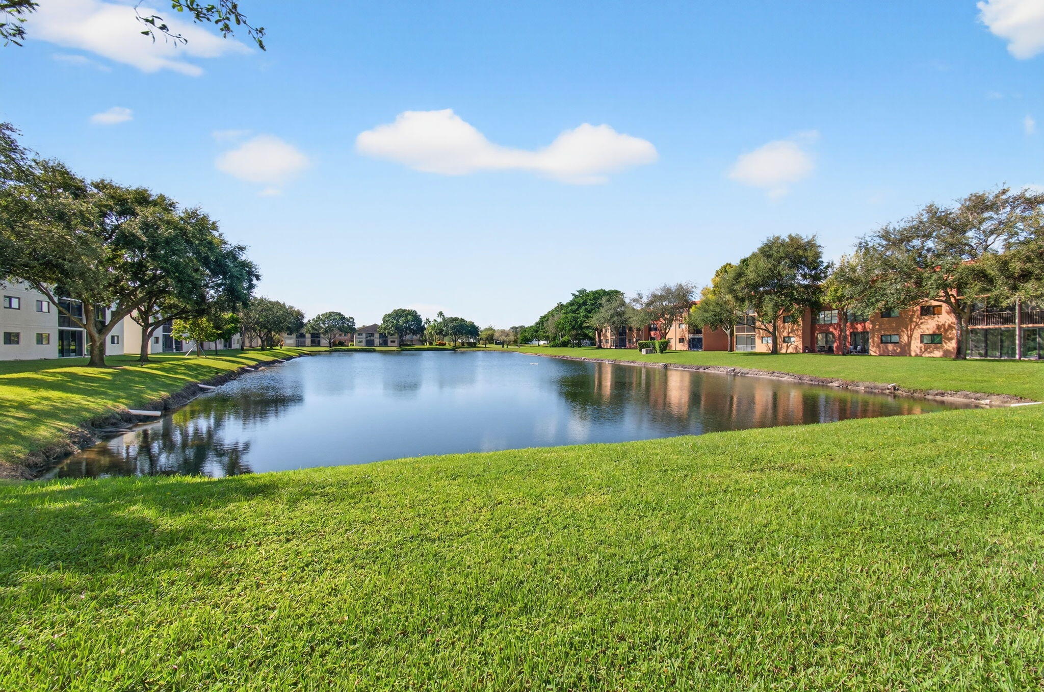 5574 Witney Drive, Unit 109 Delray Beach, FL 33484 - Photo 26 of 114 a view of a lake with houses in the background