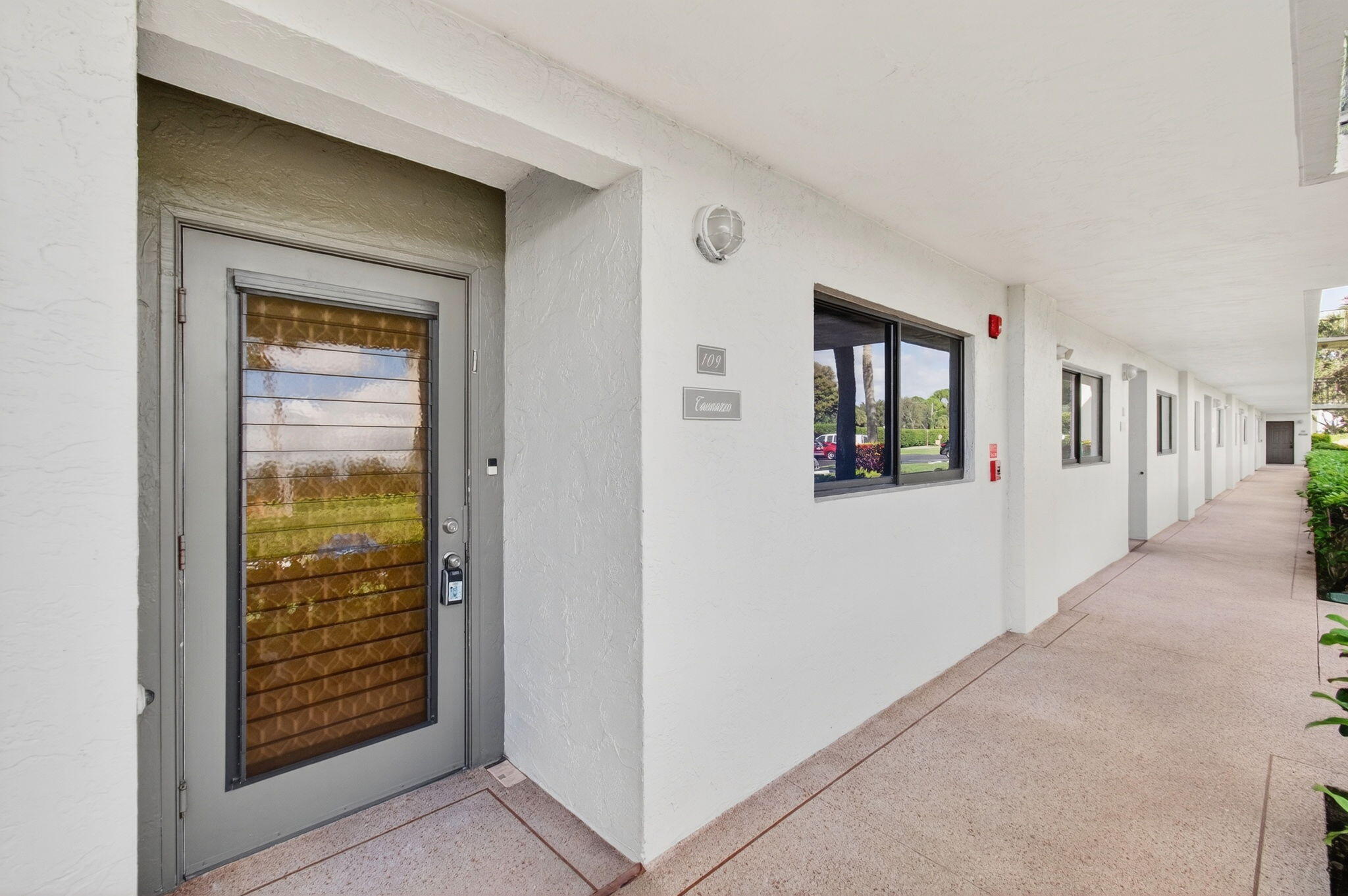5574 Witney Drive, Unit 109 Delray Beach, FL 33484 - Photo 30 of 114 a view of a hallway with wooden floor and a living room