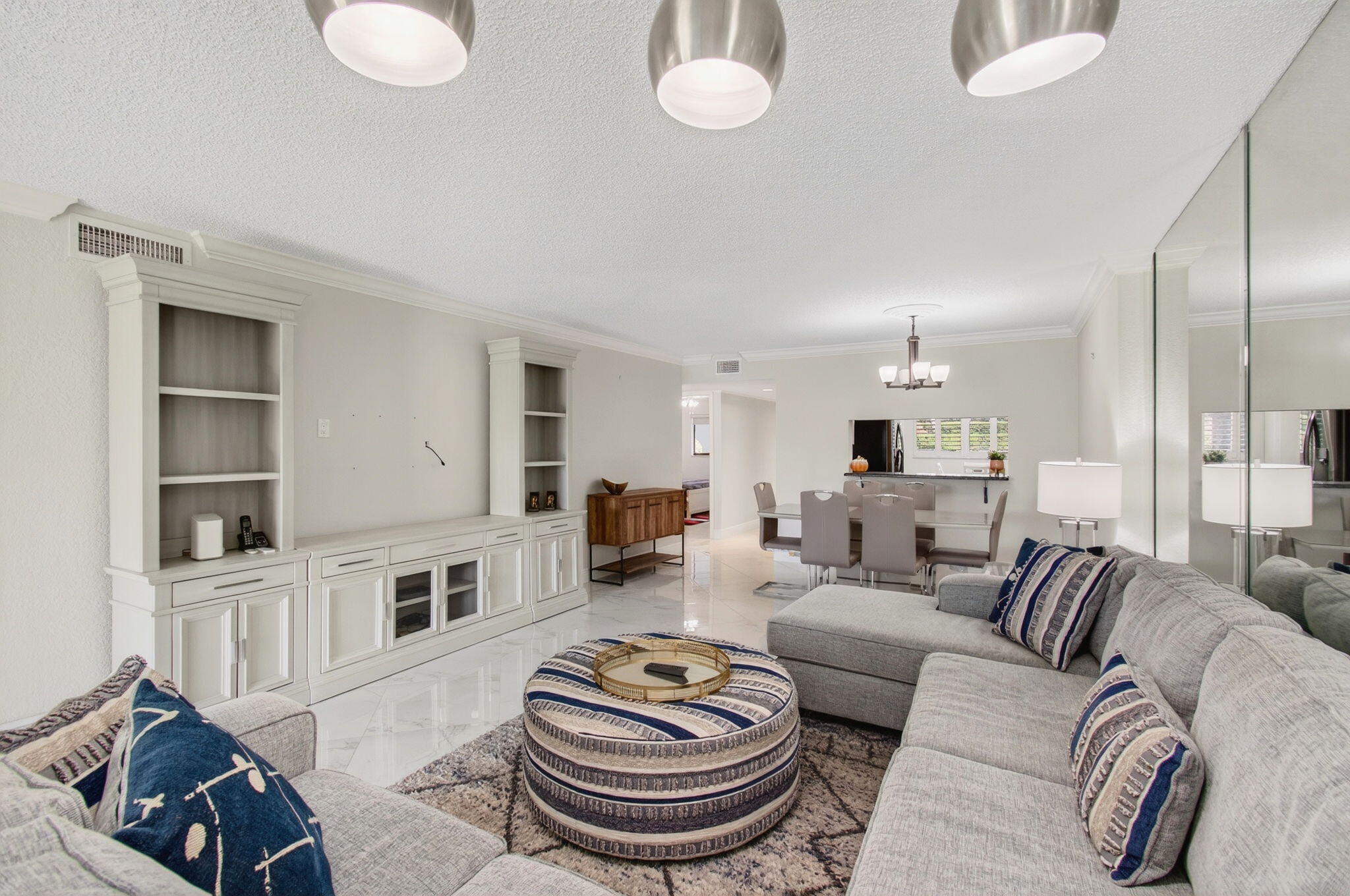 5574 Witney Drive, Unit 109 Delray Beach, FL 33484 - Photo 38 of 114 a living room with furniture and a book shelf