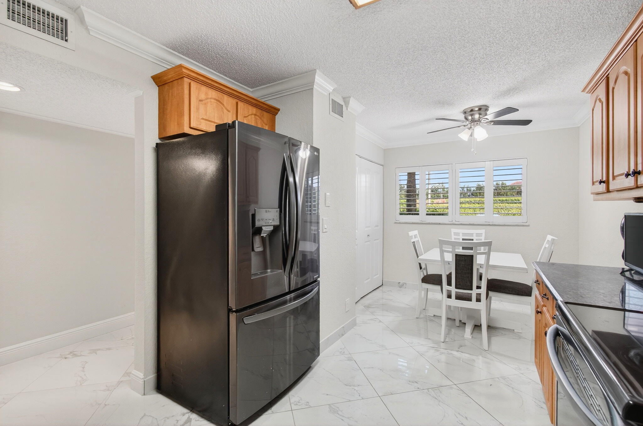 5574 Witney Drive, Unit 109 Delray Beach, FL 33484 - Photo 43 of 114 a kitchen with stainless steel appliances granite countertop a refrigerator and a stove top oven