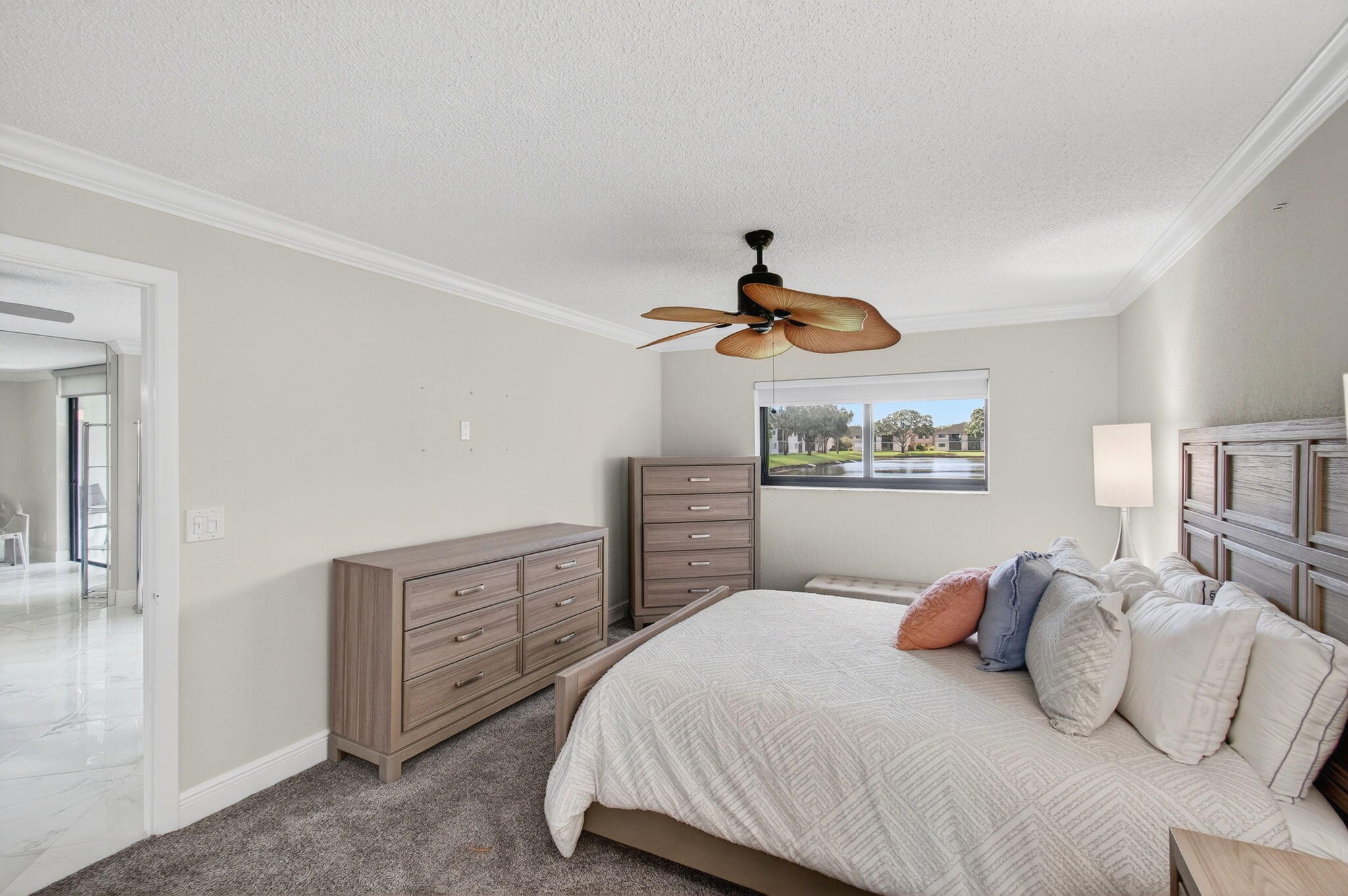 5574 Witney Drive, Unit 109 Delray Beach, FL 33484 - Photo 53 of 114 a bedroom with a bed and dresser