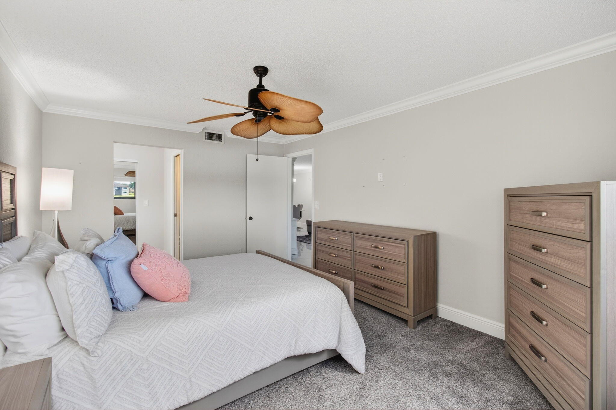 5574 Witney Drive, Unit 109 Delray Beach, FL 33484 - Photo 54 of 114 a bedroom with a bed and a chandelier