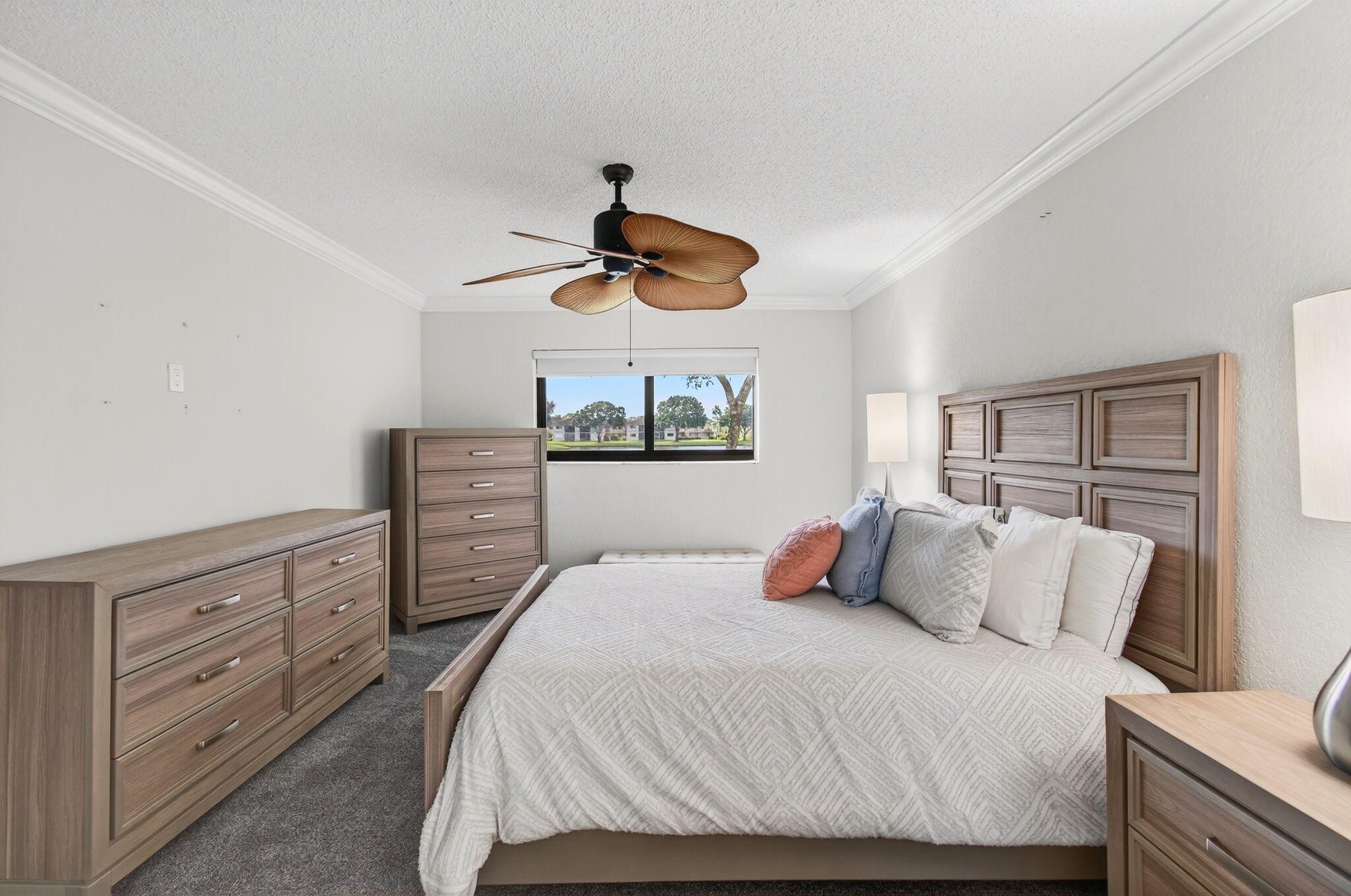 5574 Witney Drive, Unit 109 Delray Beach, FL 33484 - Photo 55 of 114 a bedroom with a large bed and a chandelier