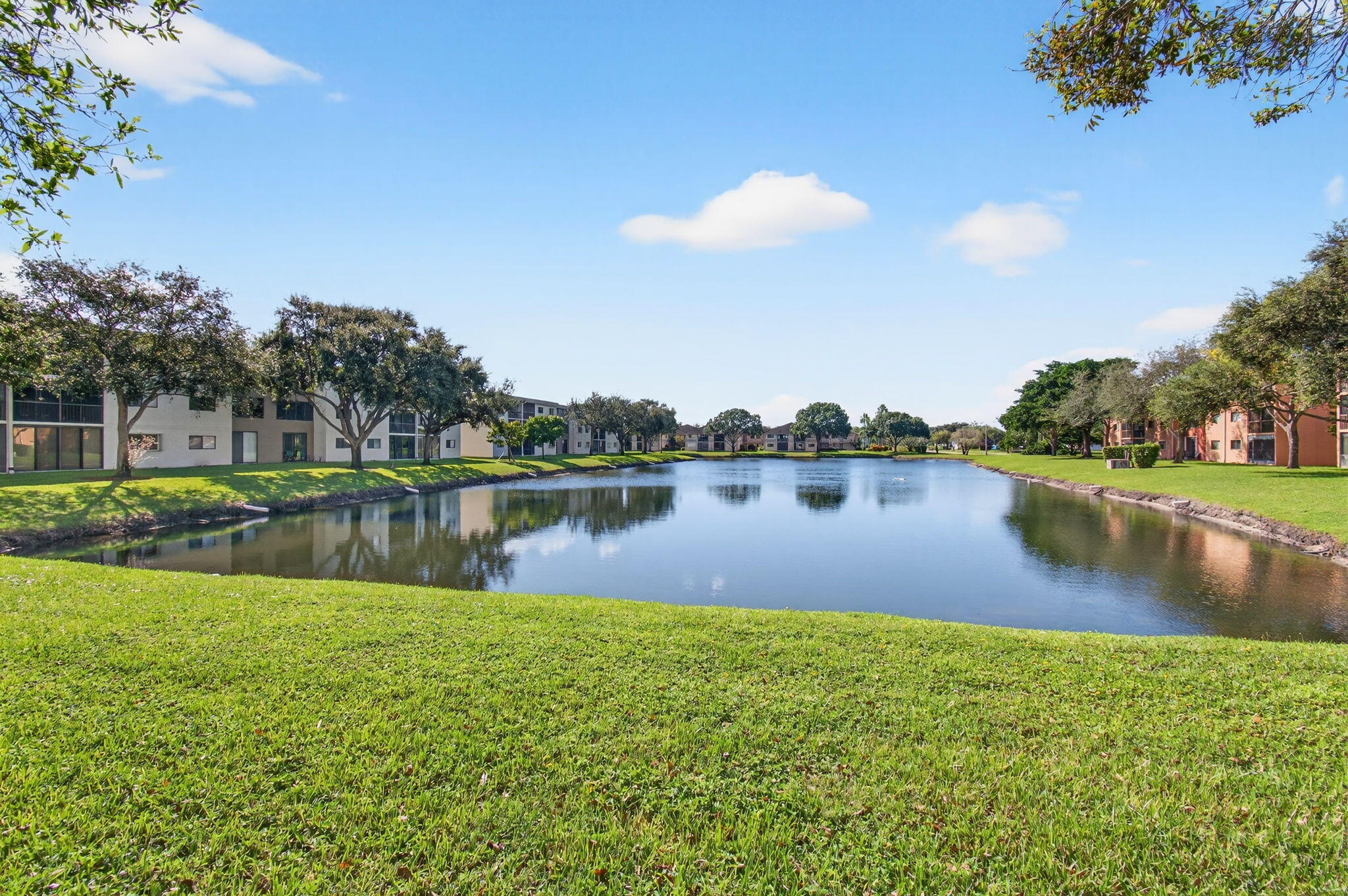 5574 Witney Drive, Unit 109 Delray Beach, FL 33484 - Photo 6 of 114 a view of a lake with a yard and mountain view
