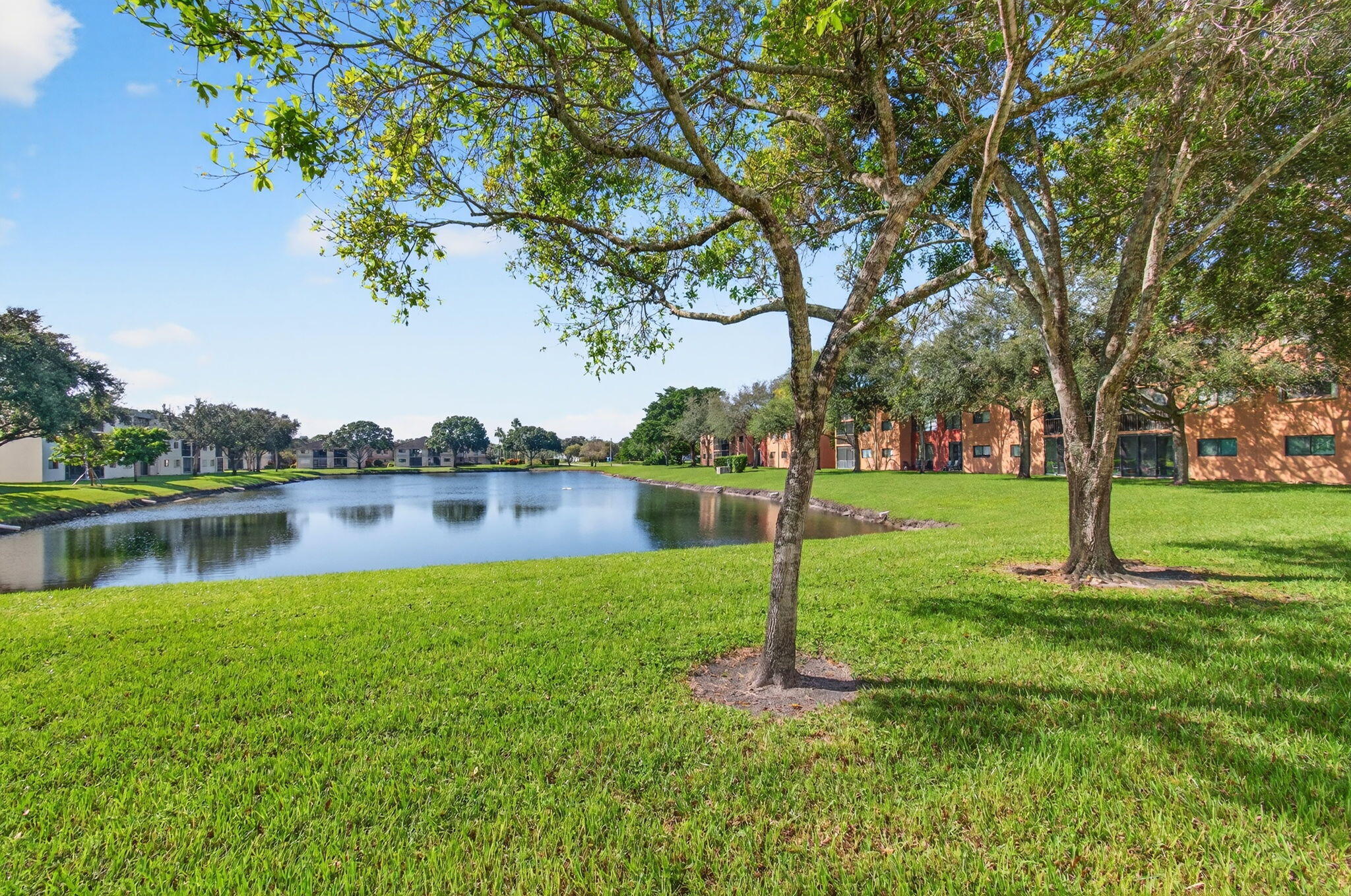 5574 Witney Drive, Unit 109 Delray Beach, FL 33484 - Photo 61 of 114 a backyard of a house with lots of green space