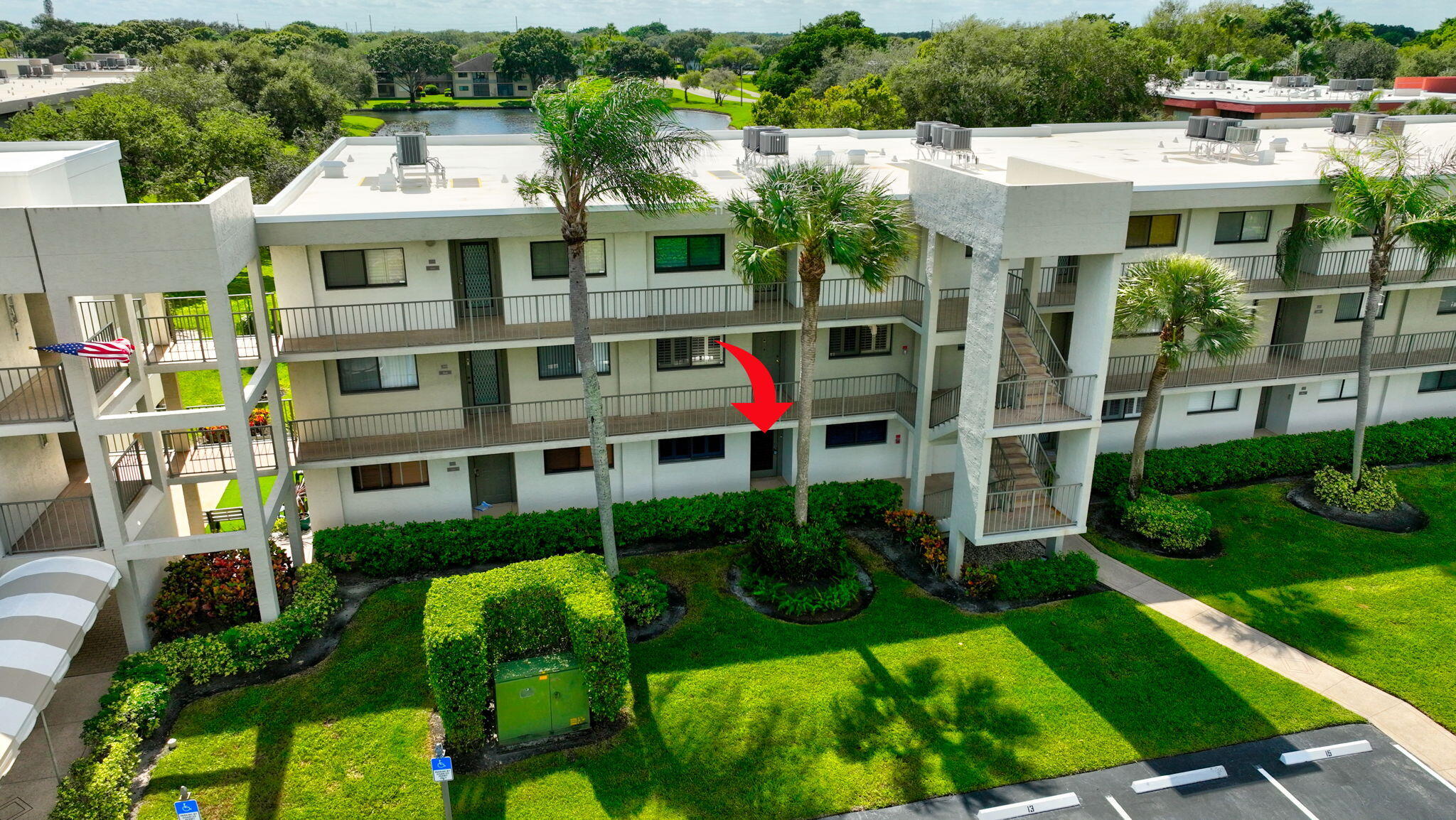 5574 Witney Drive, Unit 109 Delray Beach, FL 33484 - Photo 63 of 114 a front view of a house with a yard and potted plants