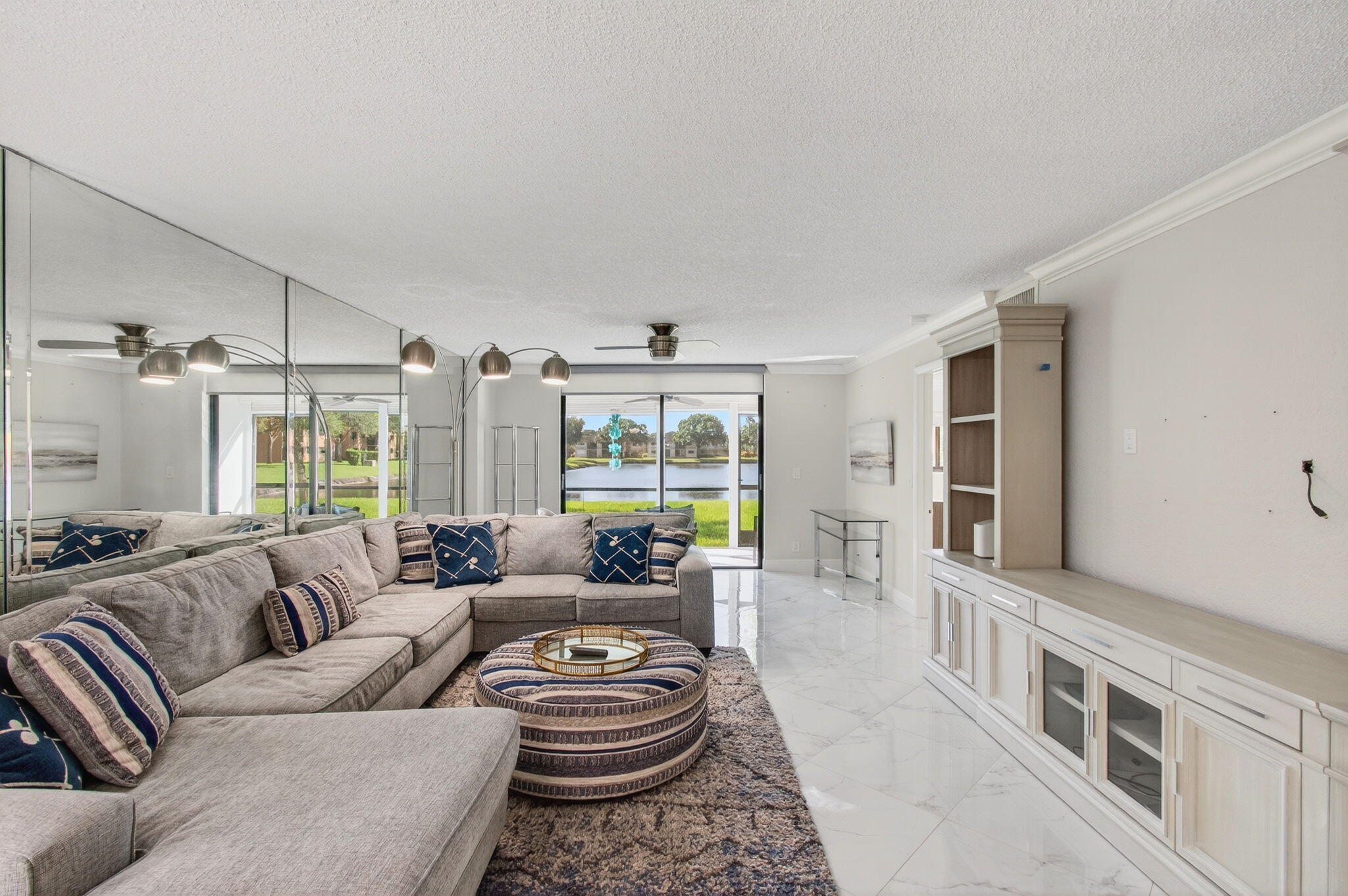 5574 Witney Drive, Unit 109 Delray Beach, FL 33484 - Photo 7 of 114 a living room with furniture and a large window